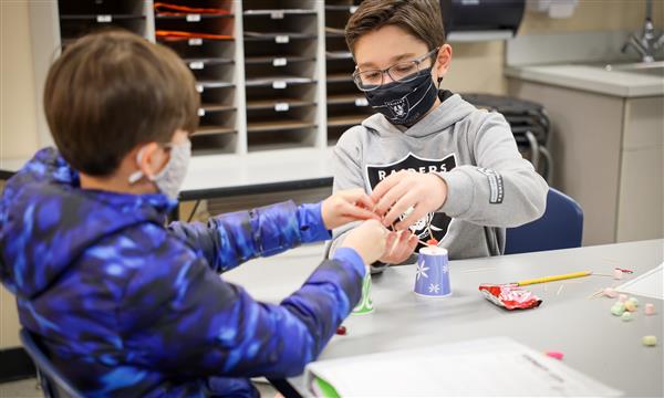 students work to build a bridge